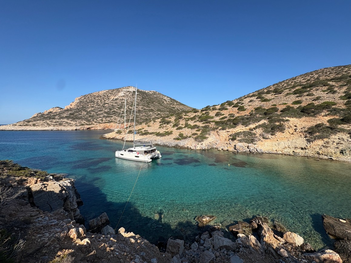 A sailing catamaran in a Greek island cover